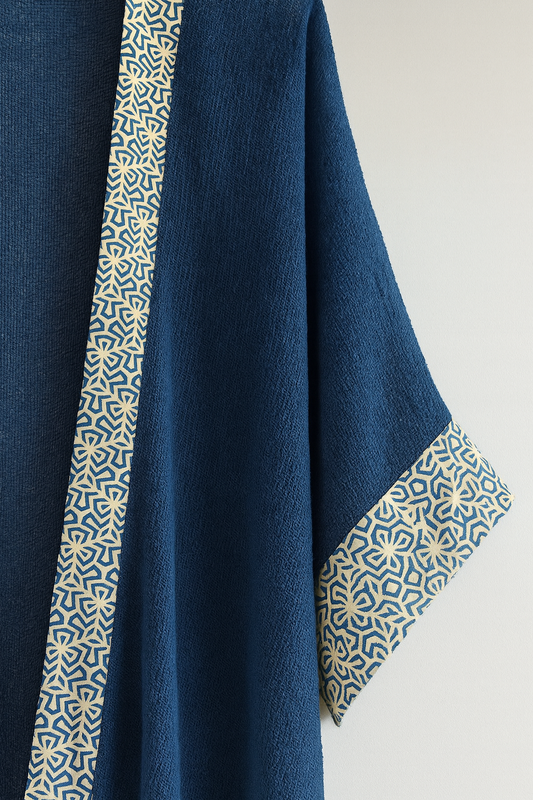 Navy blue fabric with geometric patterned trim on a light background