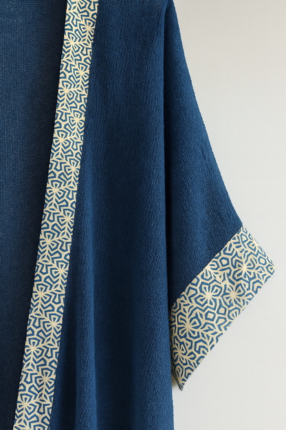Navy blue fabric with geometric patterned trim on a light background